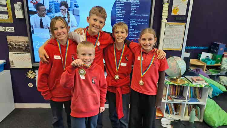 Group of students wearing medals won at a STEM Challenge day