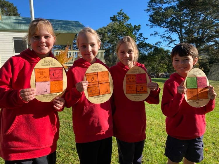 Group of students holding up egg awards
