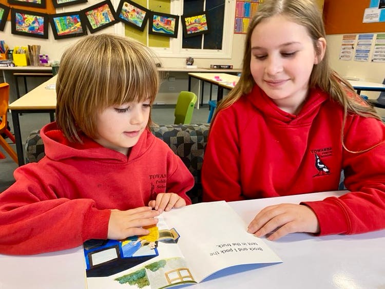 Older student mentoring a young student